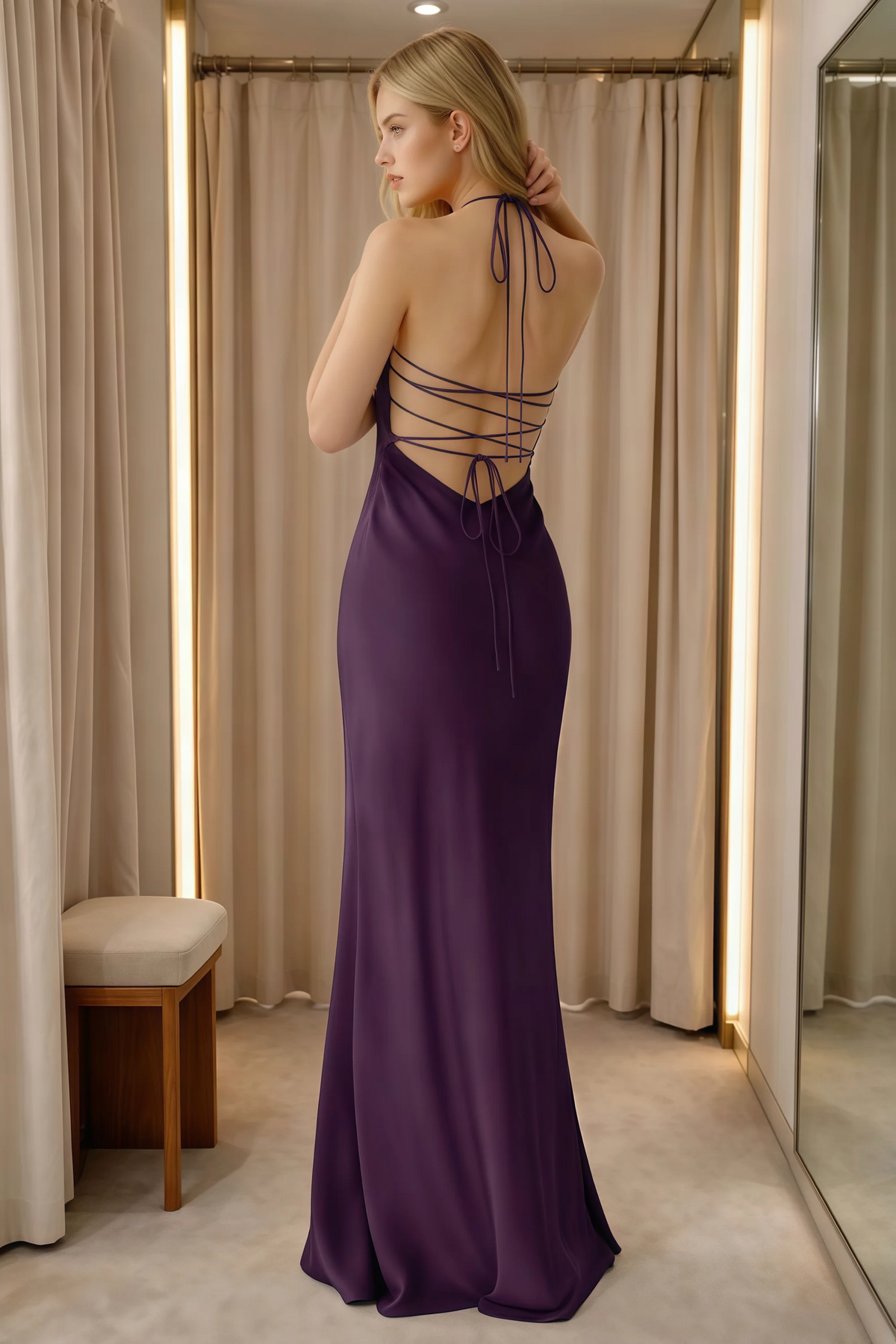 Rear indoor view of Blanche grape dress showing neck ties and lace-up back beside curtains