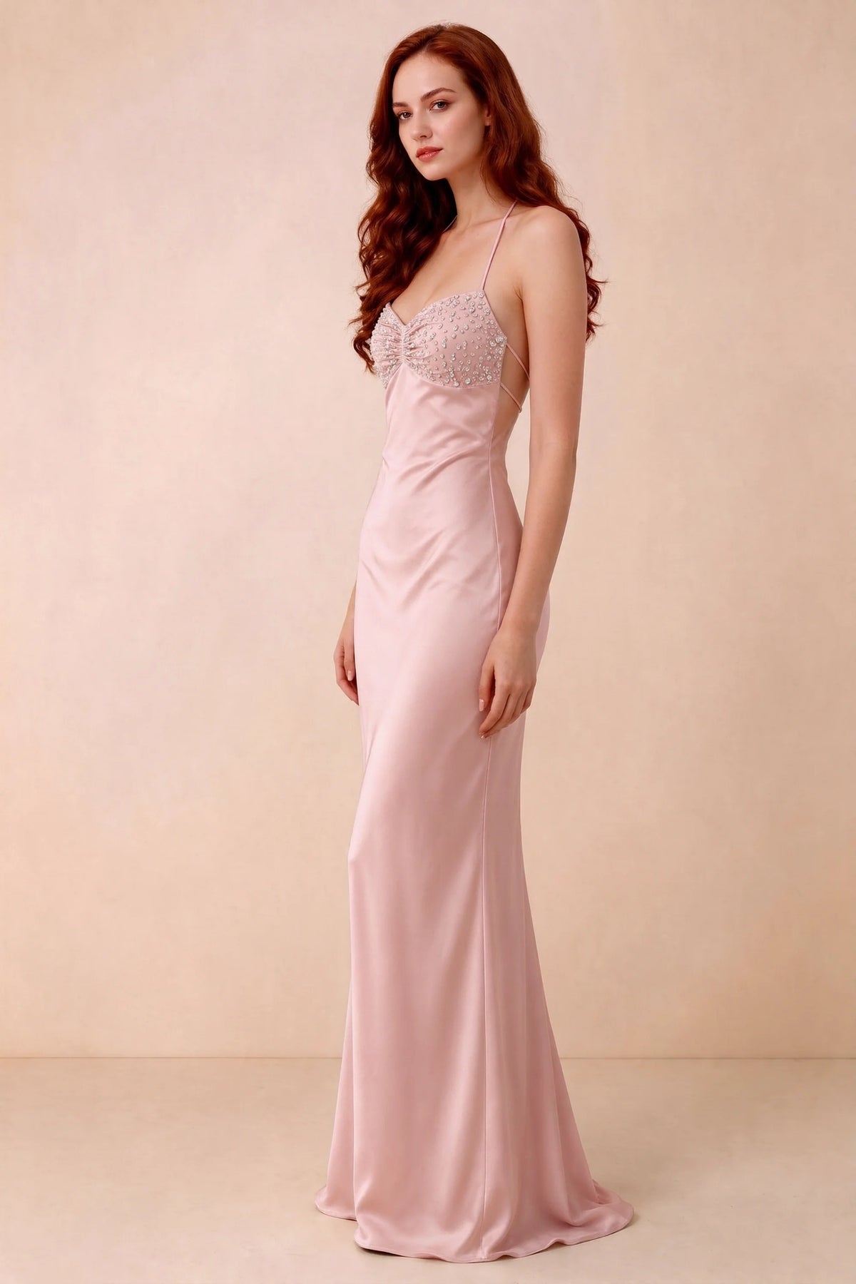 Three-quarter studio view of Blanche haze pink dress showing the fitted hips and flared long hem