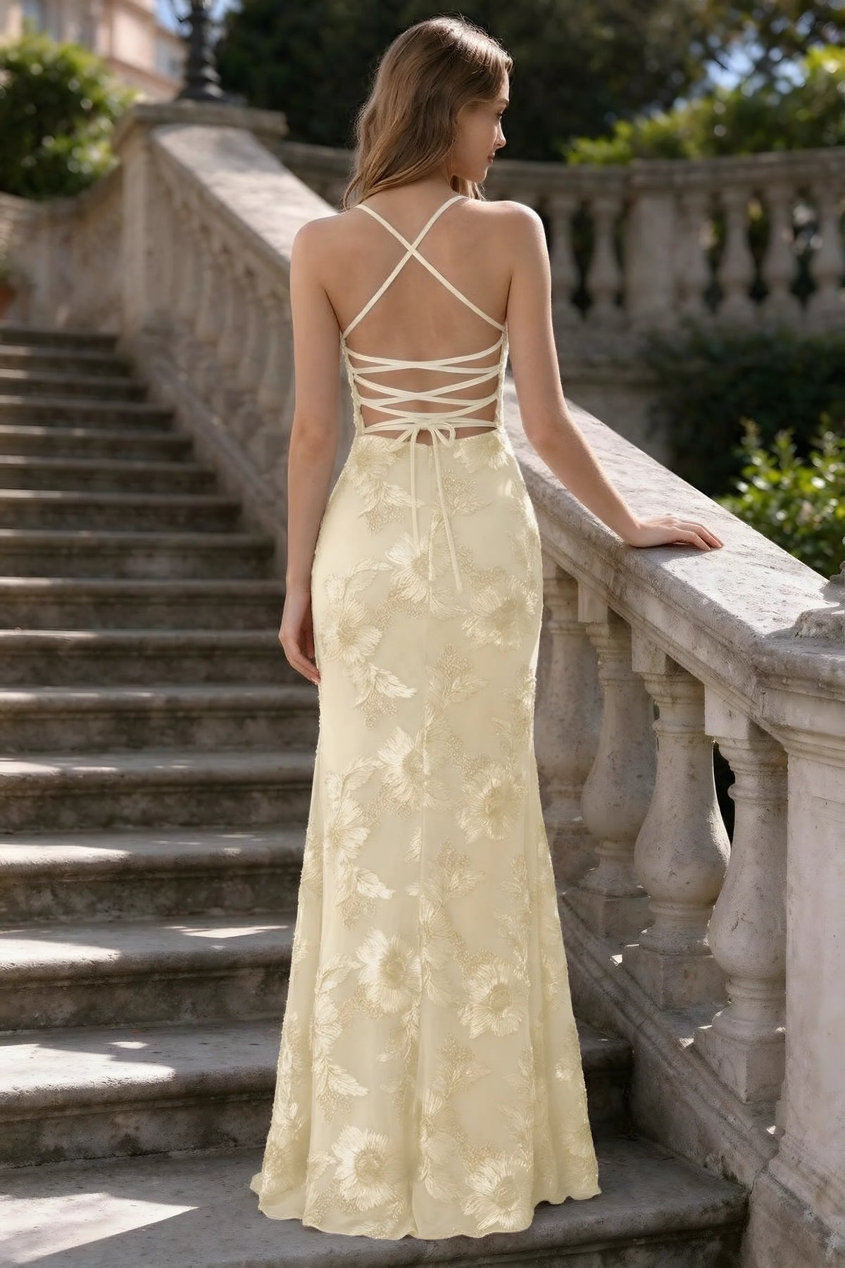 Outdoor rear view of Belinda lemon mermaid maxi dress showing the crisscross back ties