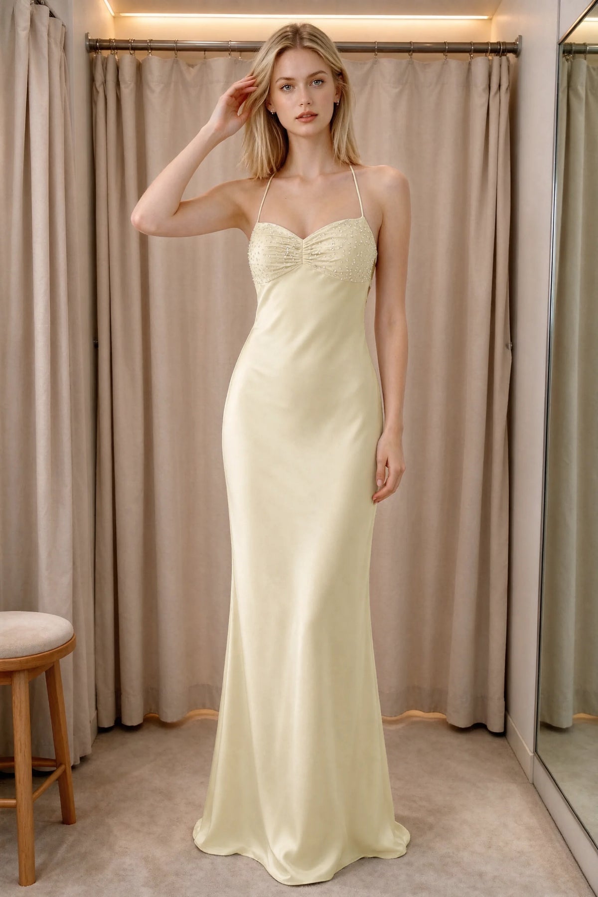 Front indoor view of Blanche lemon satin maxi dress beside curtains with a beaded bust panel