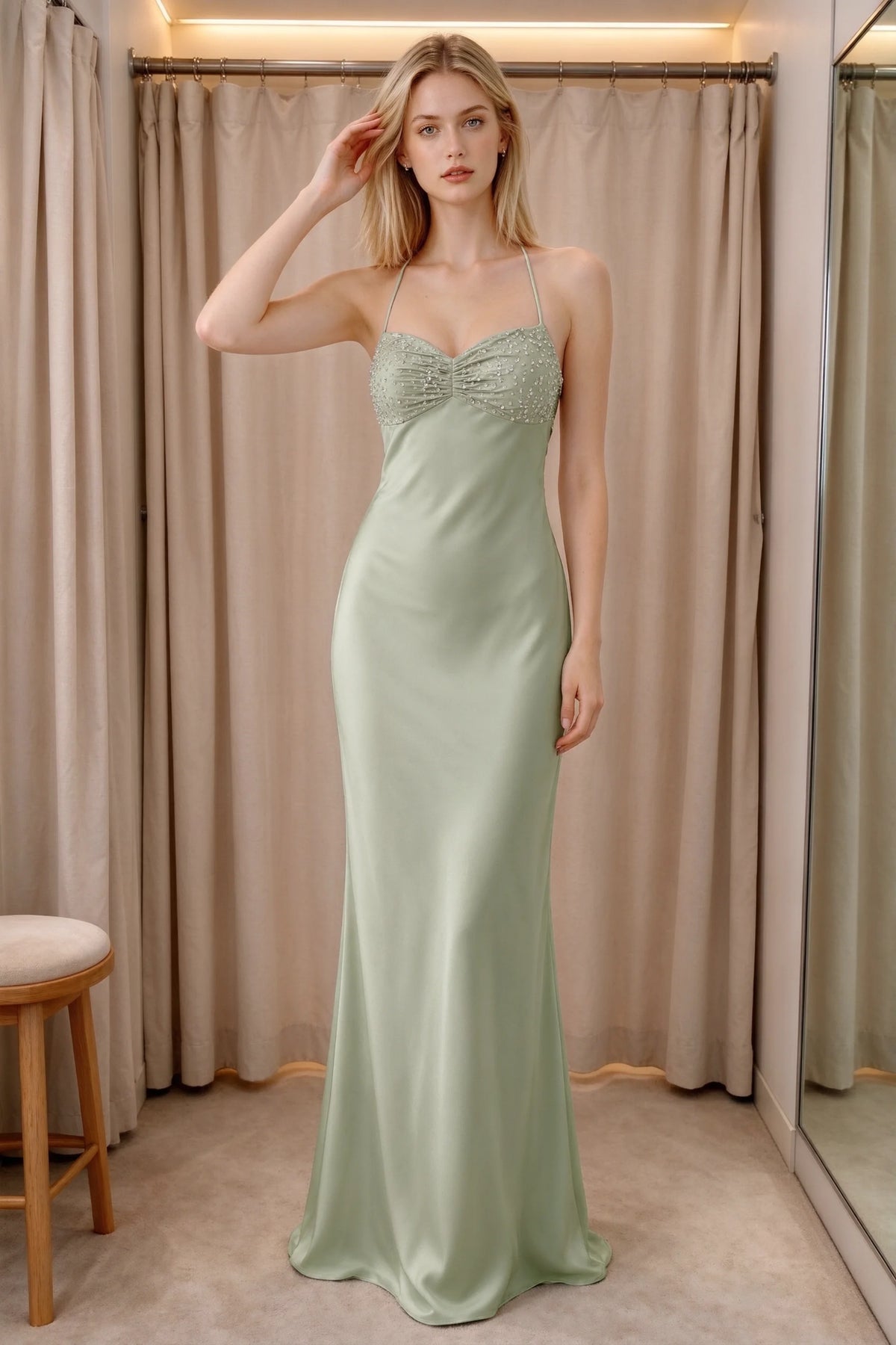 Front indoor view of Blanche light green satin maxi dress beside curtains with a beaded bust panel