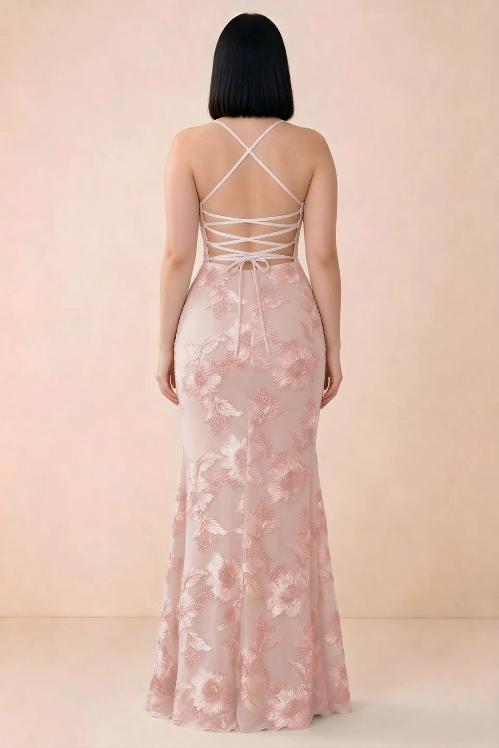 Rear studio view of Belinda light pink dress showing the open back and gently flared skirt