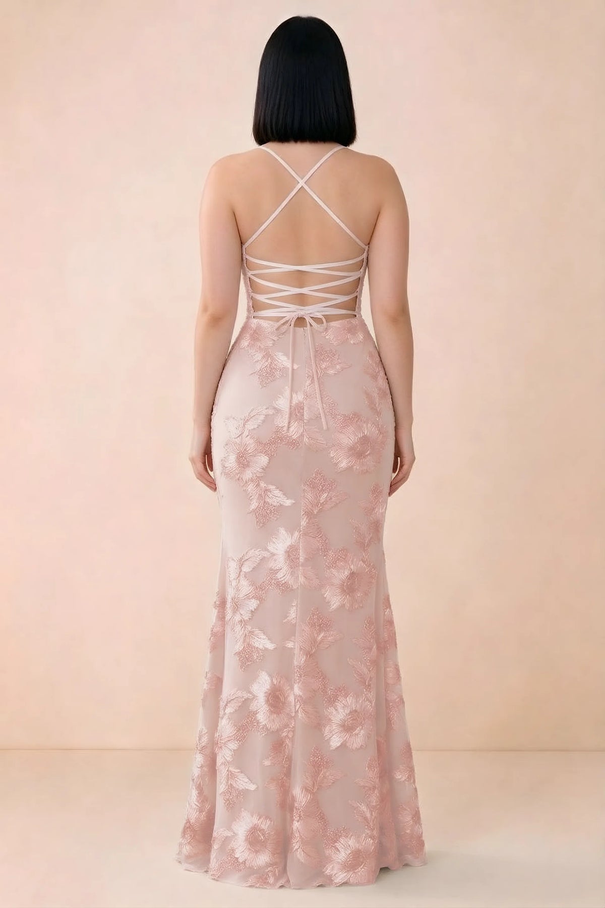 Rear studio view of Belinda light pink dress showing the open back and gently flared skirt