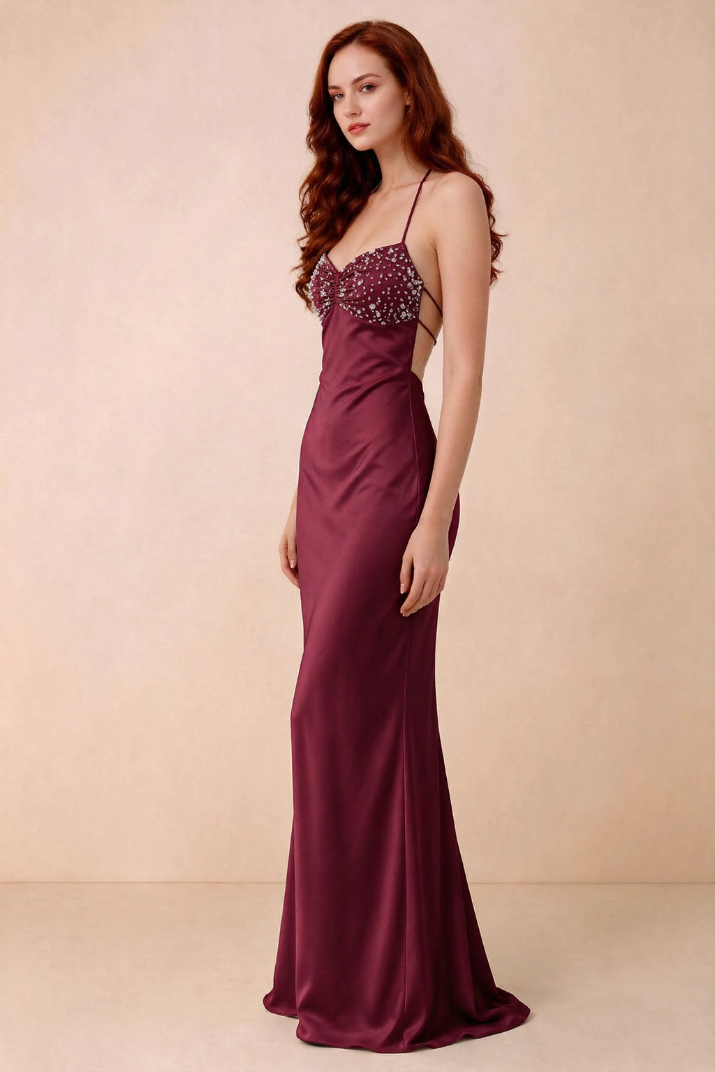 Three-quarter studio view of Blanche merlot dress showing the fitted hips and flared long hem