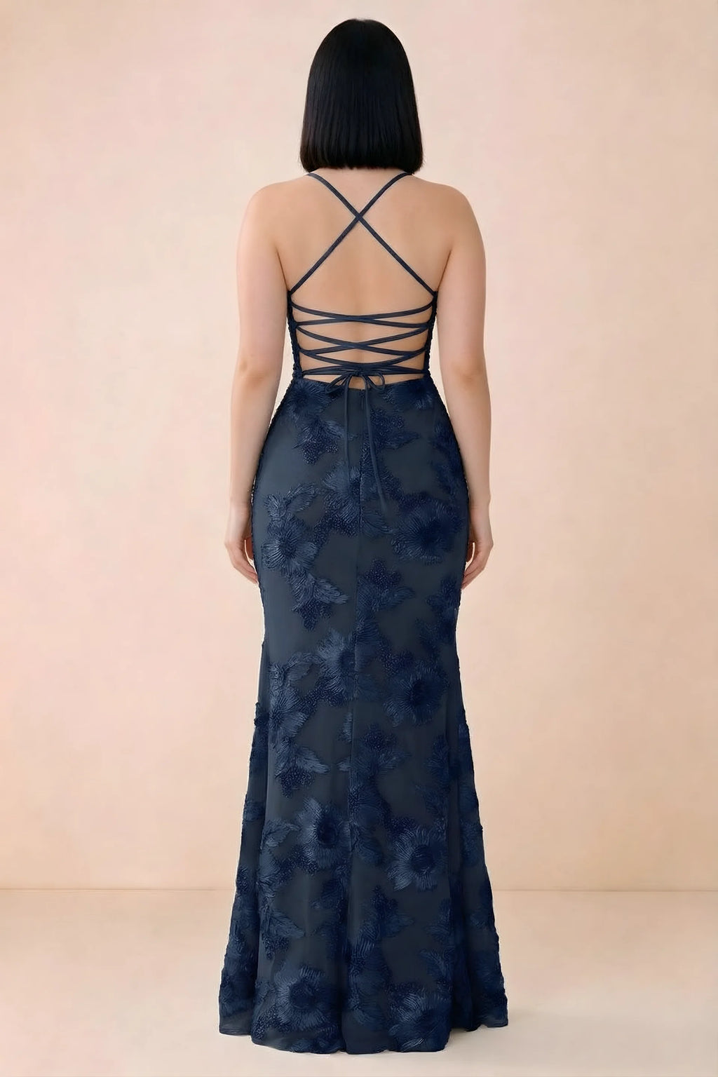 Rear studio view of Belinda navy dress showing the open back and gently flared skirt