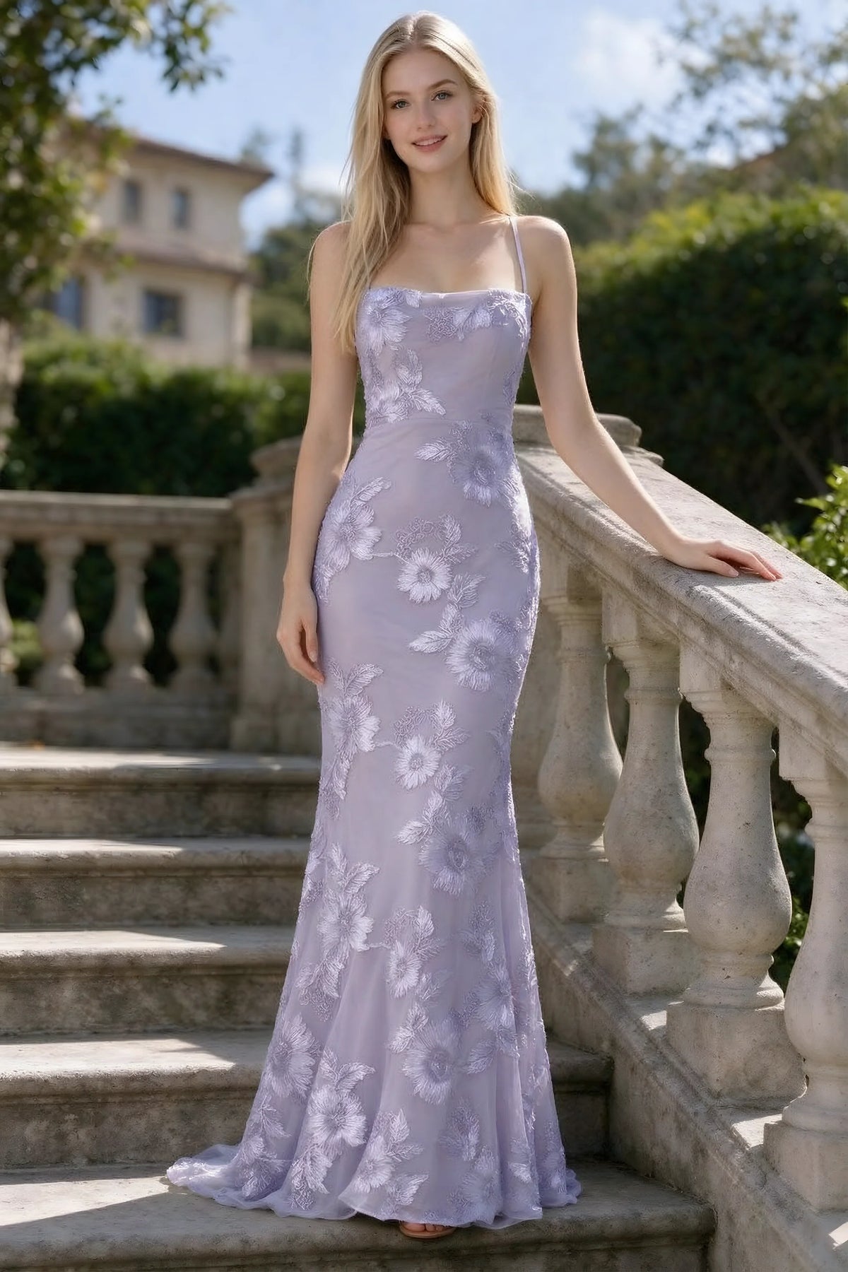 Outdoor front view of Belinda pale purple floral lace mermaid dress on stone steps
