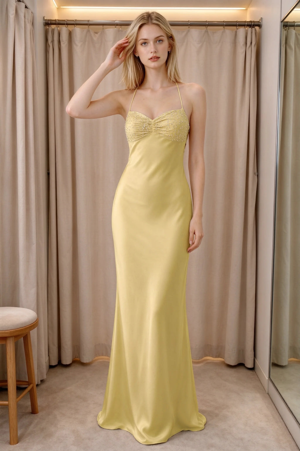 Front indoor view of Blanche pastel yellow satin maxi dress beside curtains with a beaded bust panel