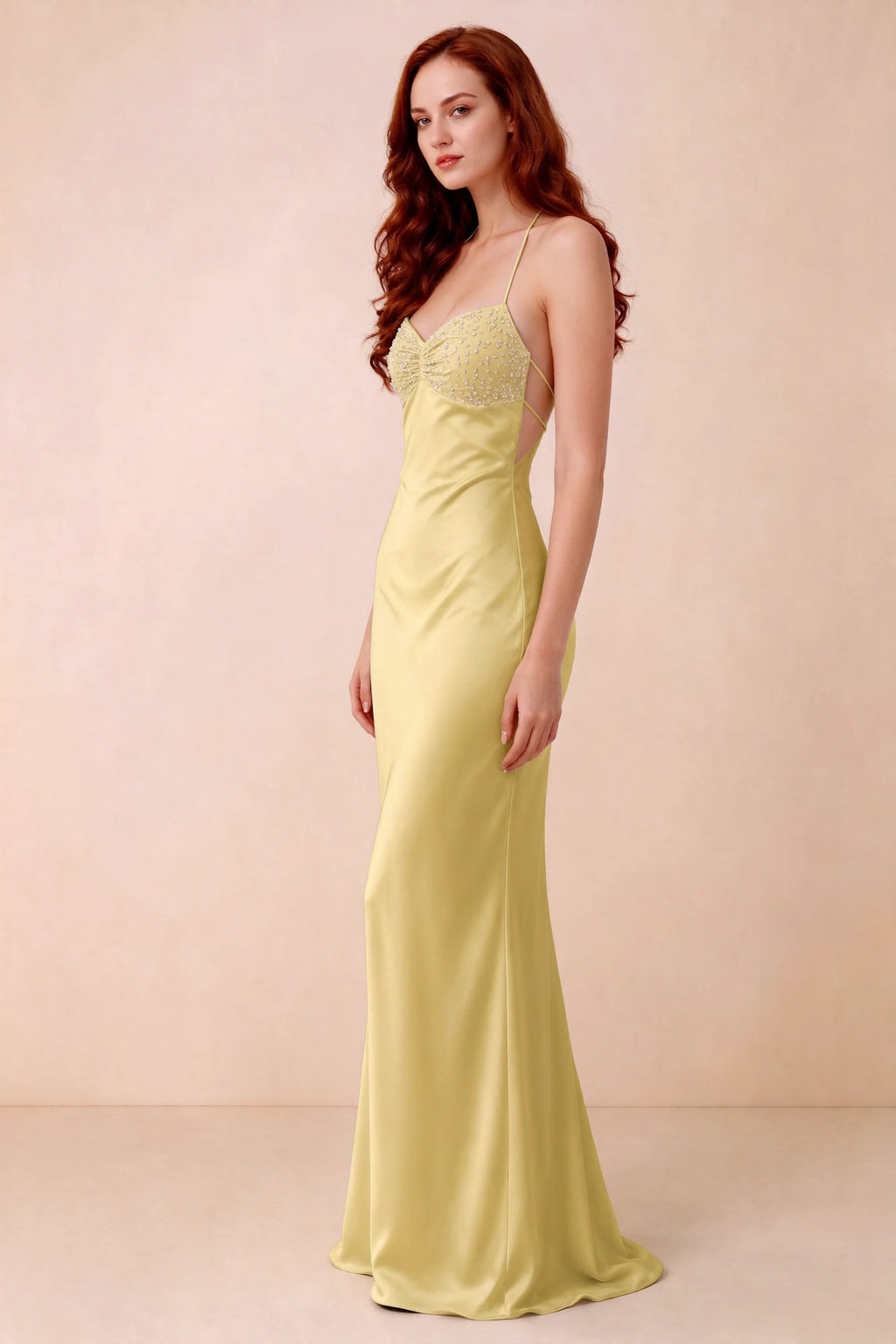 Three-quarter studio view of Blanche pastel yellow dress showing the fitted hips and flared long hem