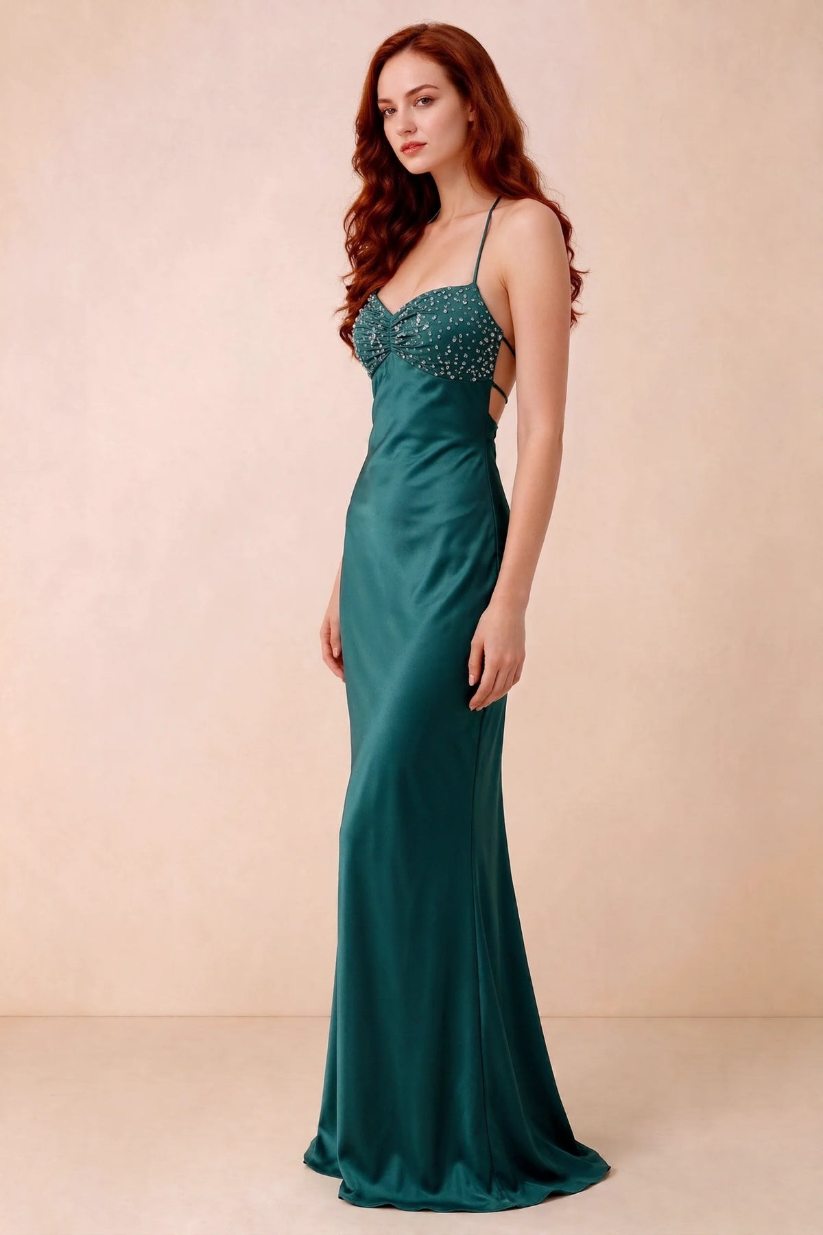 Three-quarter studio view of Blanche peacock dress showing the fitted hips and flared long hem