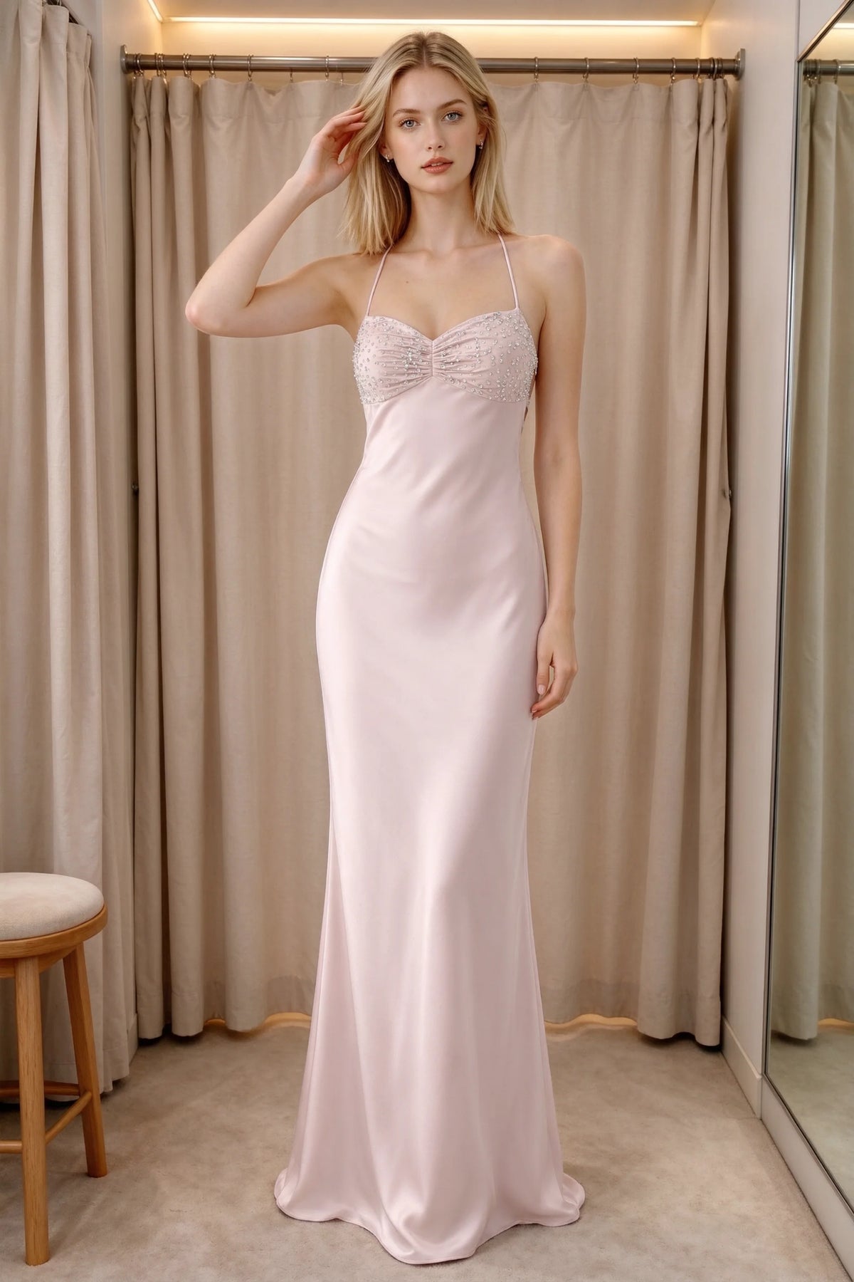Front indoor view of Blanche powder pink satin maxi dress beside curtains with a beaded bust panel