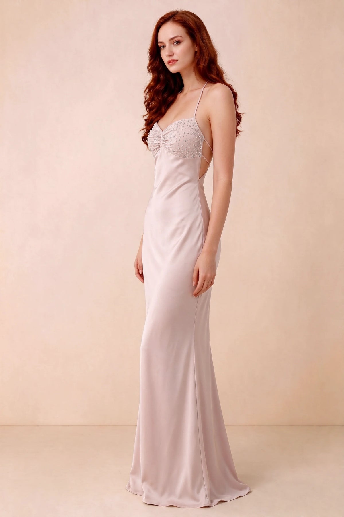 Three-quarter studio view of Blanche powder pink dress showing the fitted hips and flared long hem