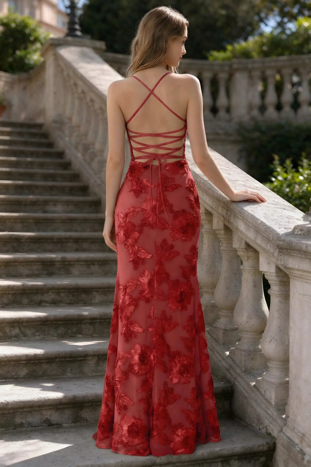 Outdoor rear view of Belinda red mermaid maxi dress showing the crisscross back ties