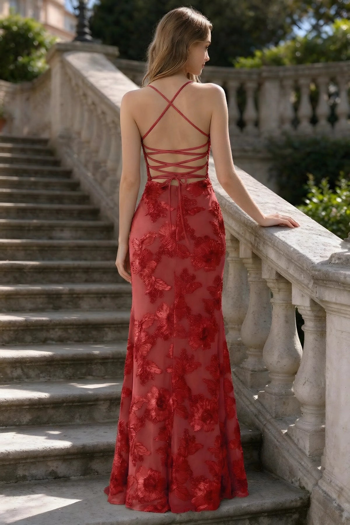 Outdoor rear view of Belinda red mermaid maxi dress showing the crisscross back ties