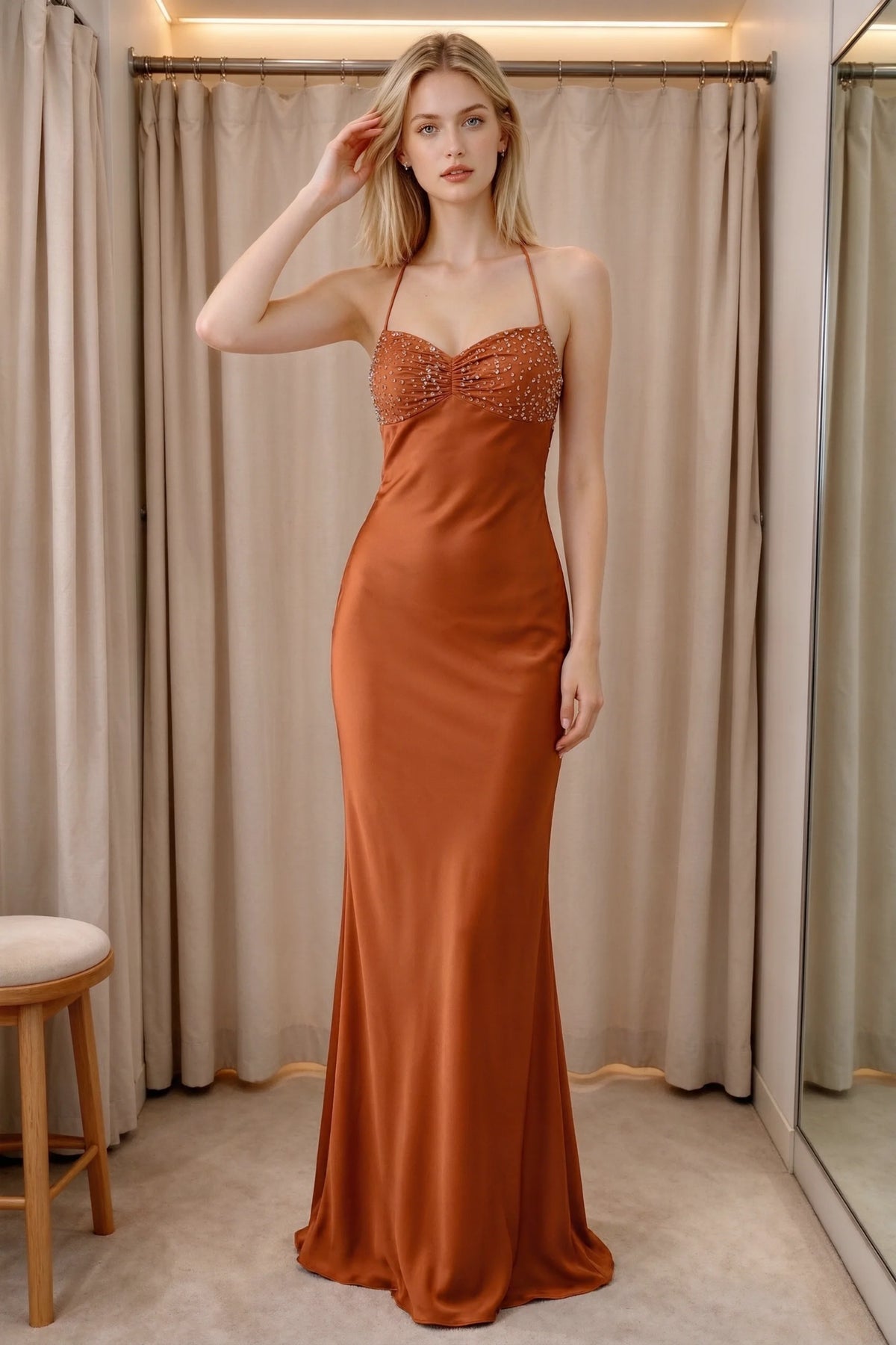 Front indoor view of Blanche rust satin maxi dress beside curtains with a beaded bust panel