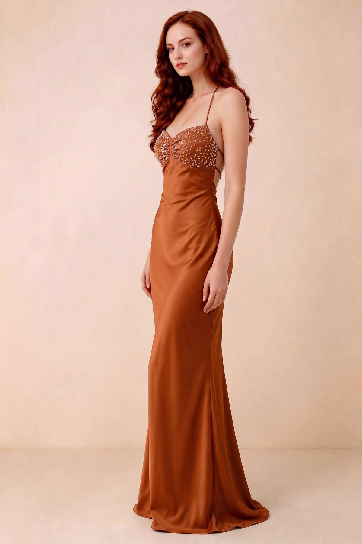 Three-quarter studio view of Blanche rust dress showing the fitted hips and flared long hem
