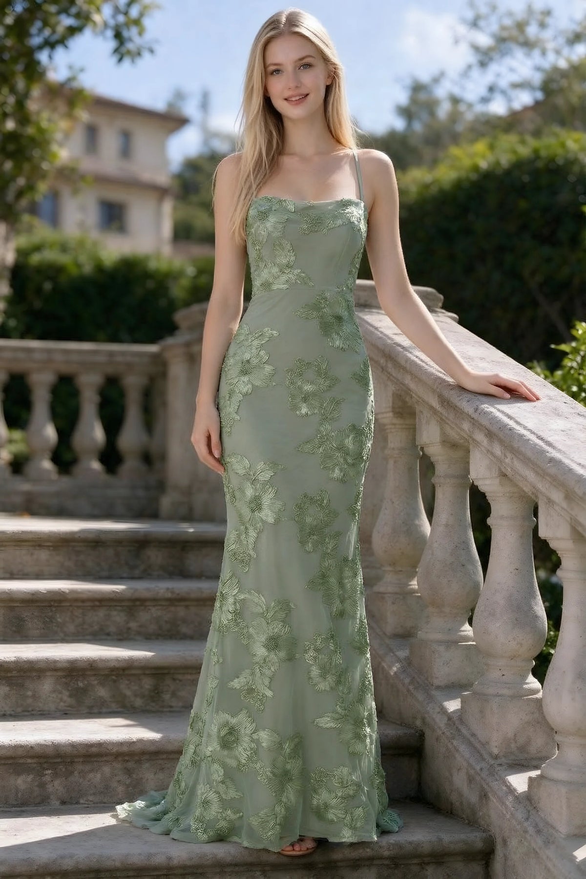Outdoor front view of Belinda sage green floral lace mermaid dress on stone steps