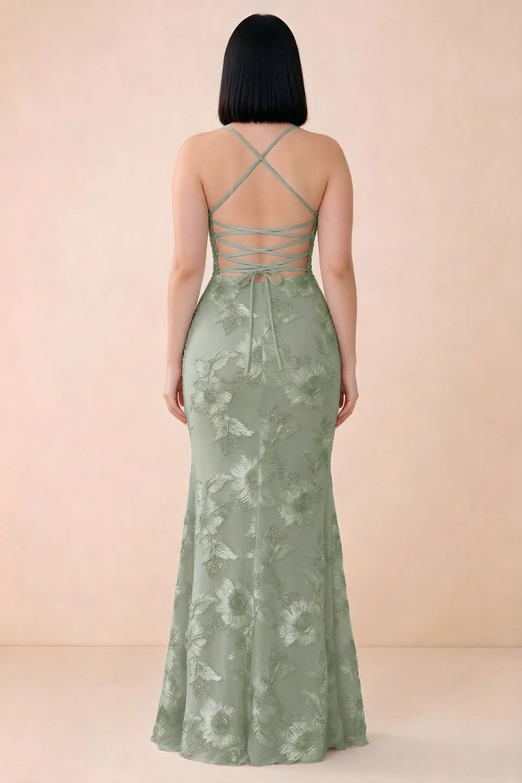 Rear studio view of Belinda sage green dress showing the open back and gently flared skirt