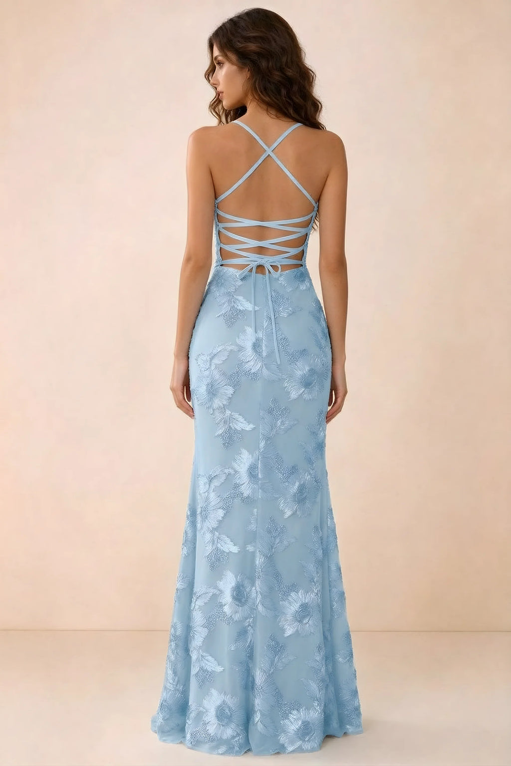 Back studio view of Belinda sky blue maxi dress showing crossed straps and open-back ties