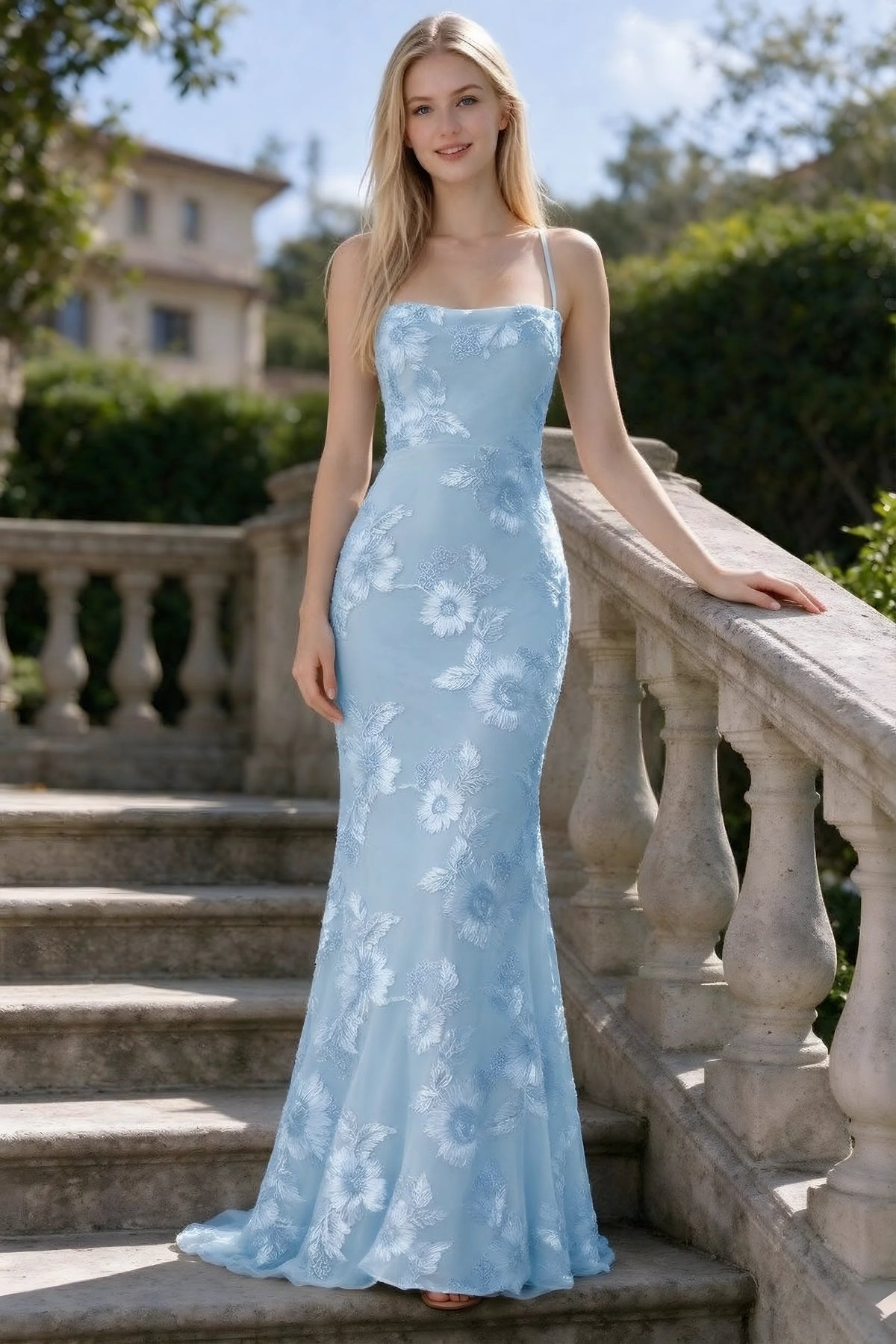 Outdoor front view of Belinda sky blue floral lace mermaid dress on stone steps