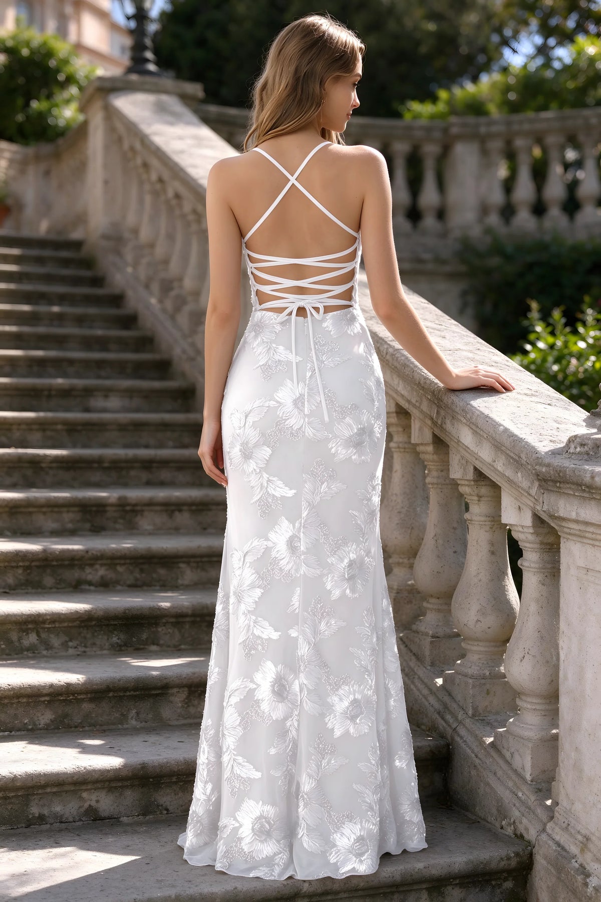 Outdoor rear view of Belinda white mermaid maxi dress showing the crisscross back ties