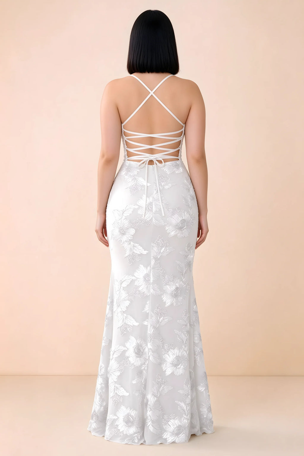Rear studio view of Belinda white dress showing the open back and gently flared skirt