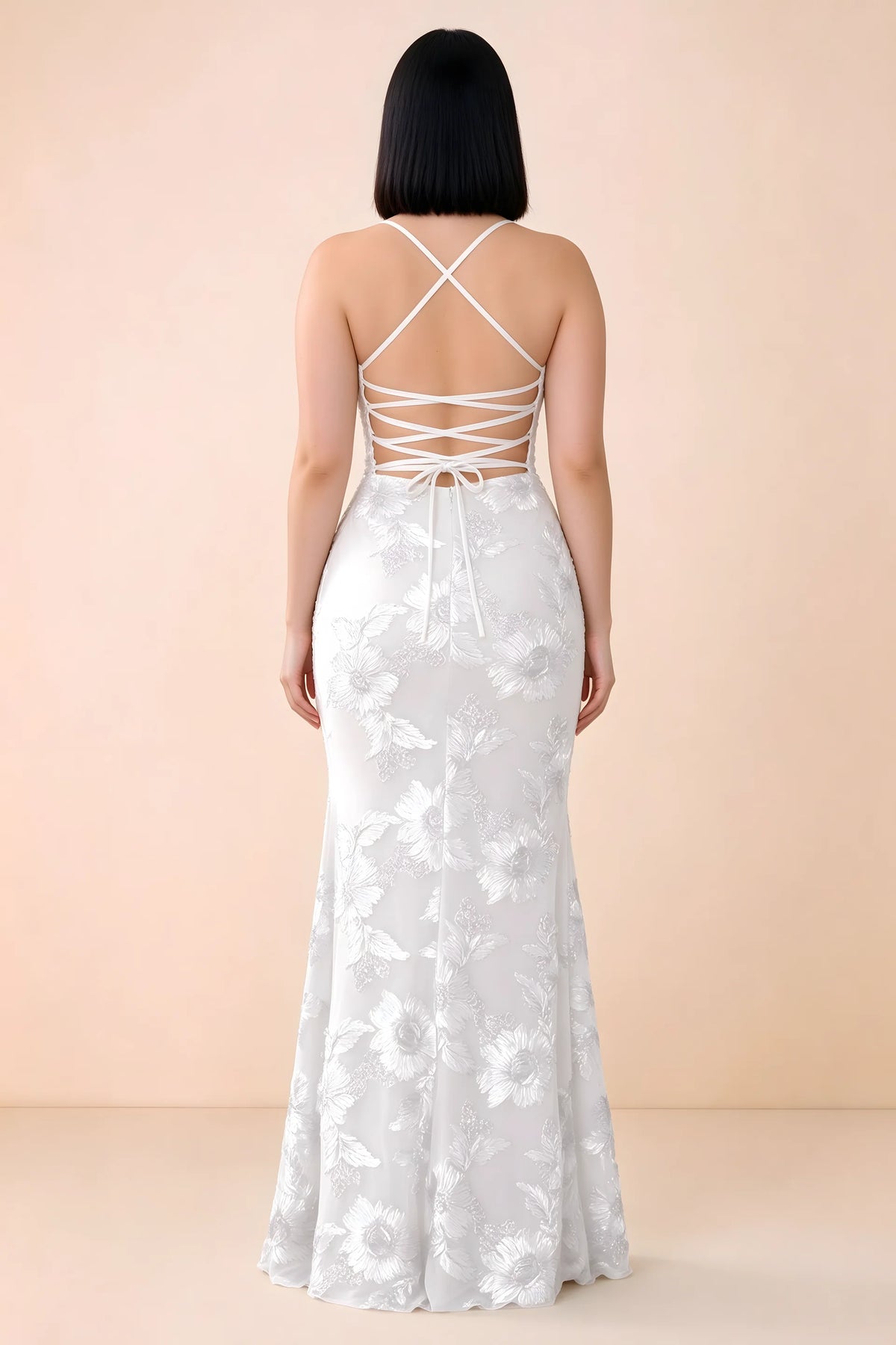 Rear studio view of Belinda white dress showing the open back and gently flared skirt