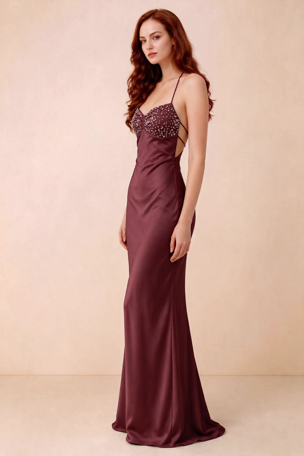 Three-quarter studio view of Blanche wine dress showing the fitted hips and flared long hem