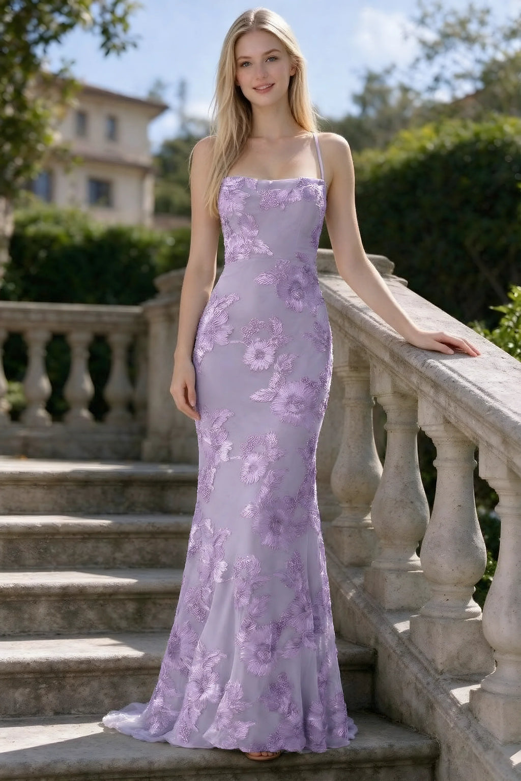 Outdoor front view of Belinda wisteria floral lace mermaid dress on stone steps