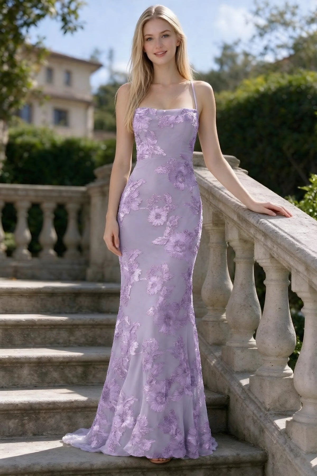 Outdoor front view of Belinda wisteria floral lace mermaid dress on stone steps