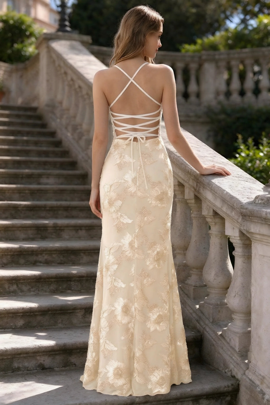 Outdoor rear view of Belinda yellow mermaid maxi dress showing the crisscross back ties