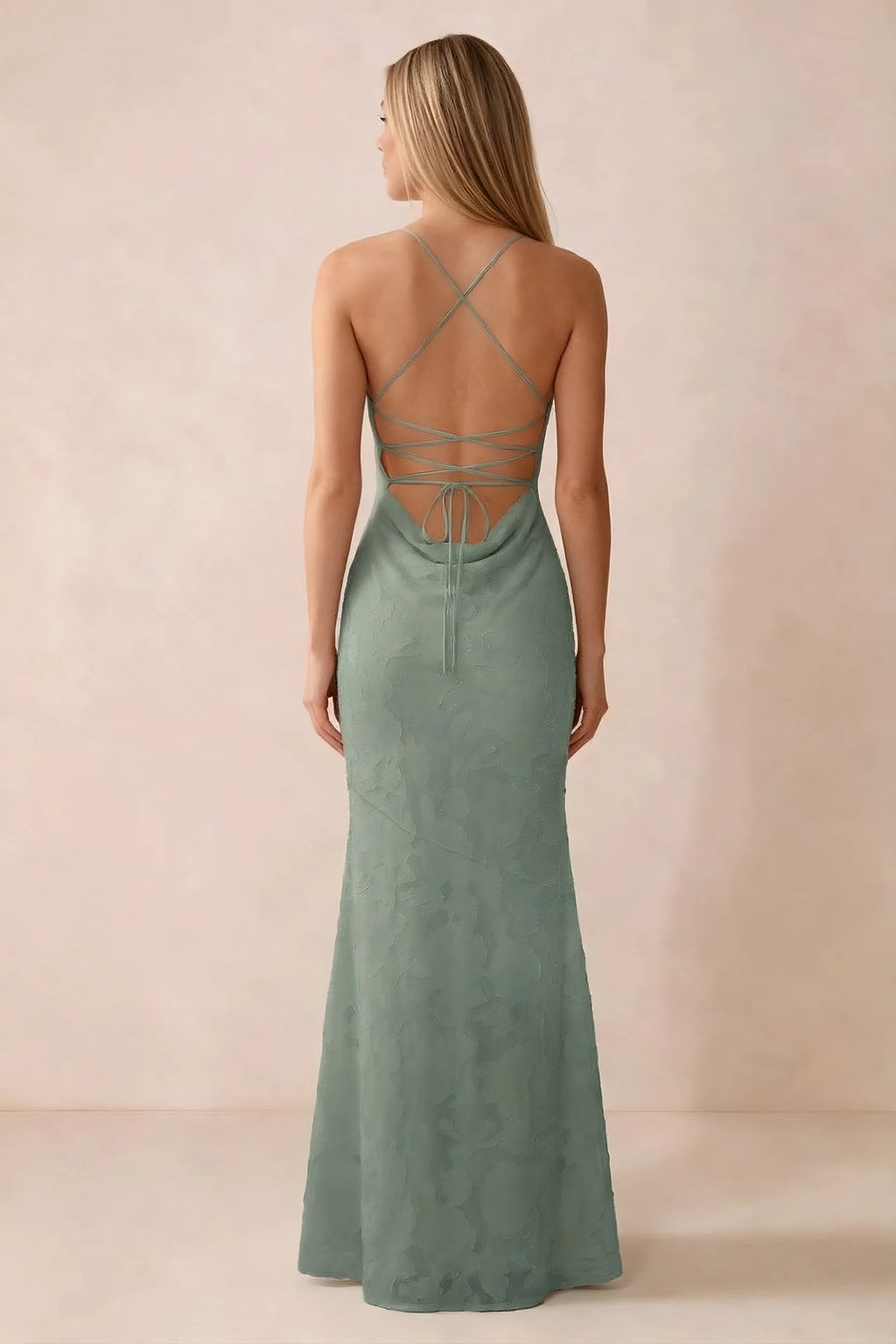 Rear studio view of Bess aloe green dress showing cross-back lacing above a low cowl drape