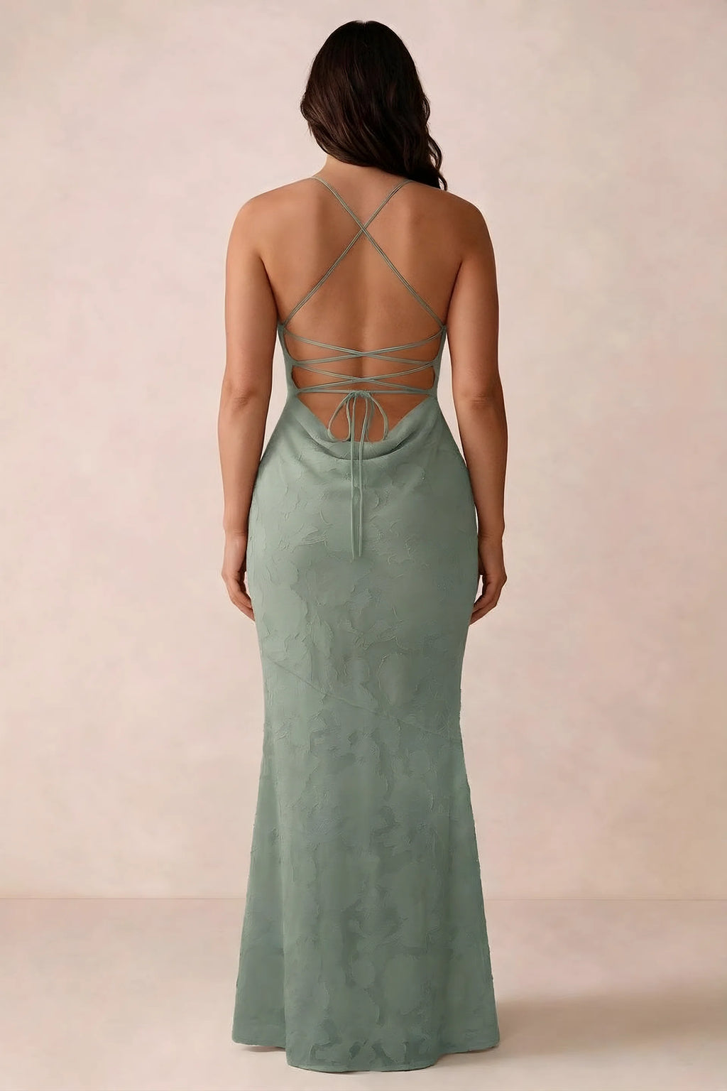 Back studio view of Bess aloe green dress showing the crossed straps and full-length silhouette