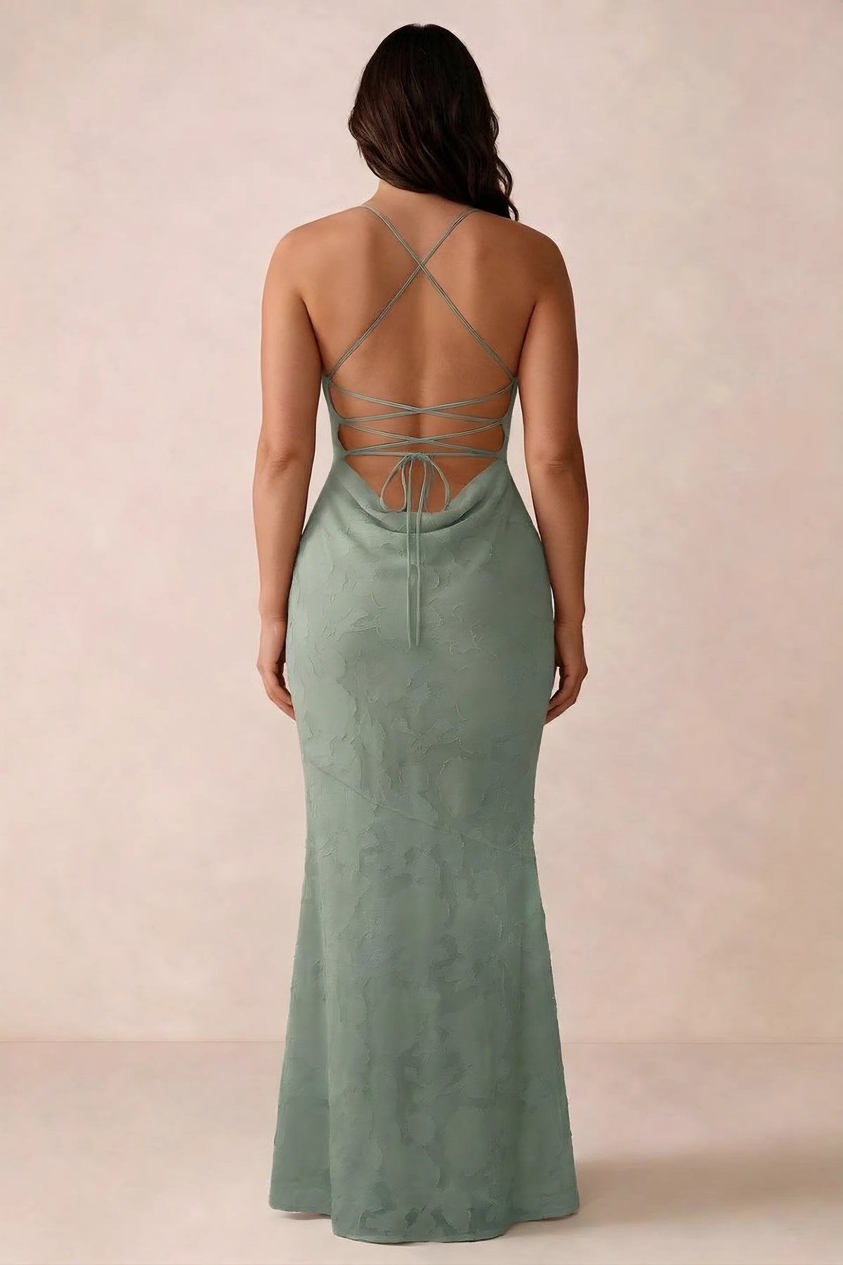 Back studio view of Bess aloe green dress showing the crossed straps and full-length silhouette