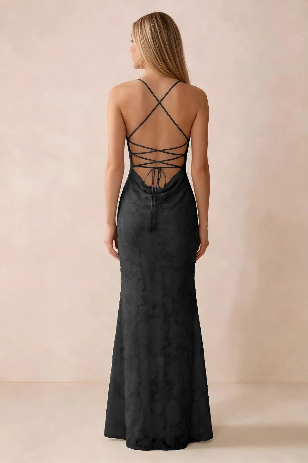 Rear studio view of Bess black dress showing cross-back lacing above a low cowl drape
