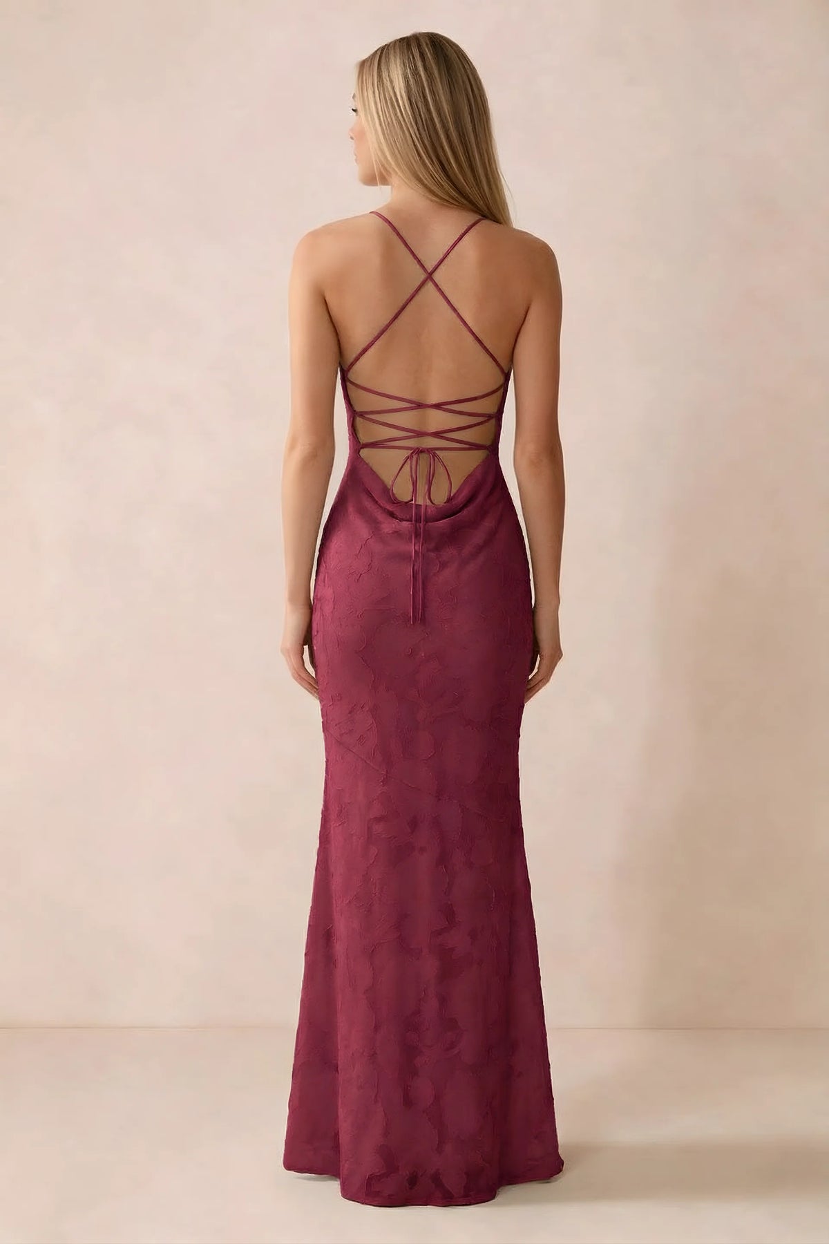Rear studio view of Bess burgundy dress showing cross-back lacing above a low cowl drape