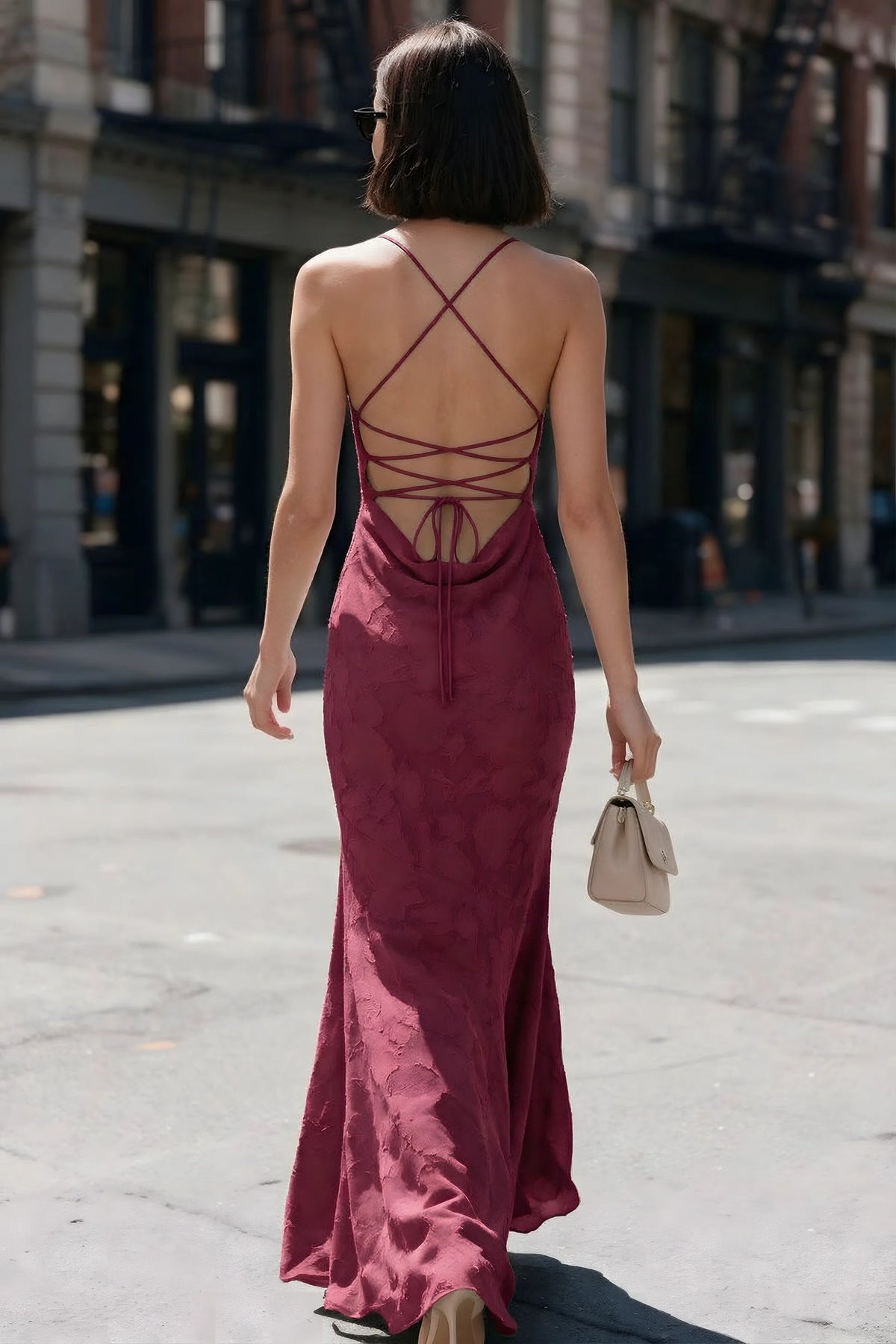 Outdoor back view of Bess burgundy maxi dress showing the open back and crisscross ties