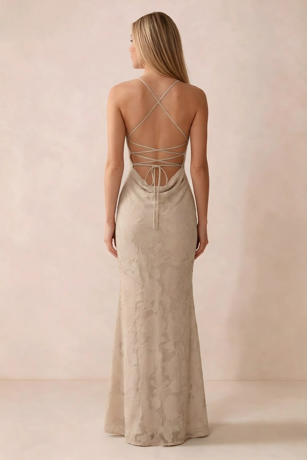 Rear studio view of Bess champagne dress showing cross-back lacing above a low cowl drape