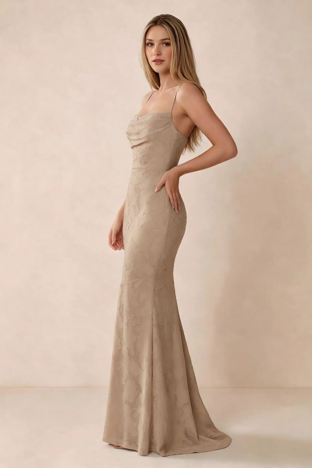 Three-quarter studio view of Bess champagne dress showing the close-fitting waist and gently flared hem