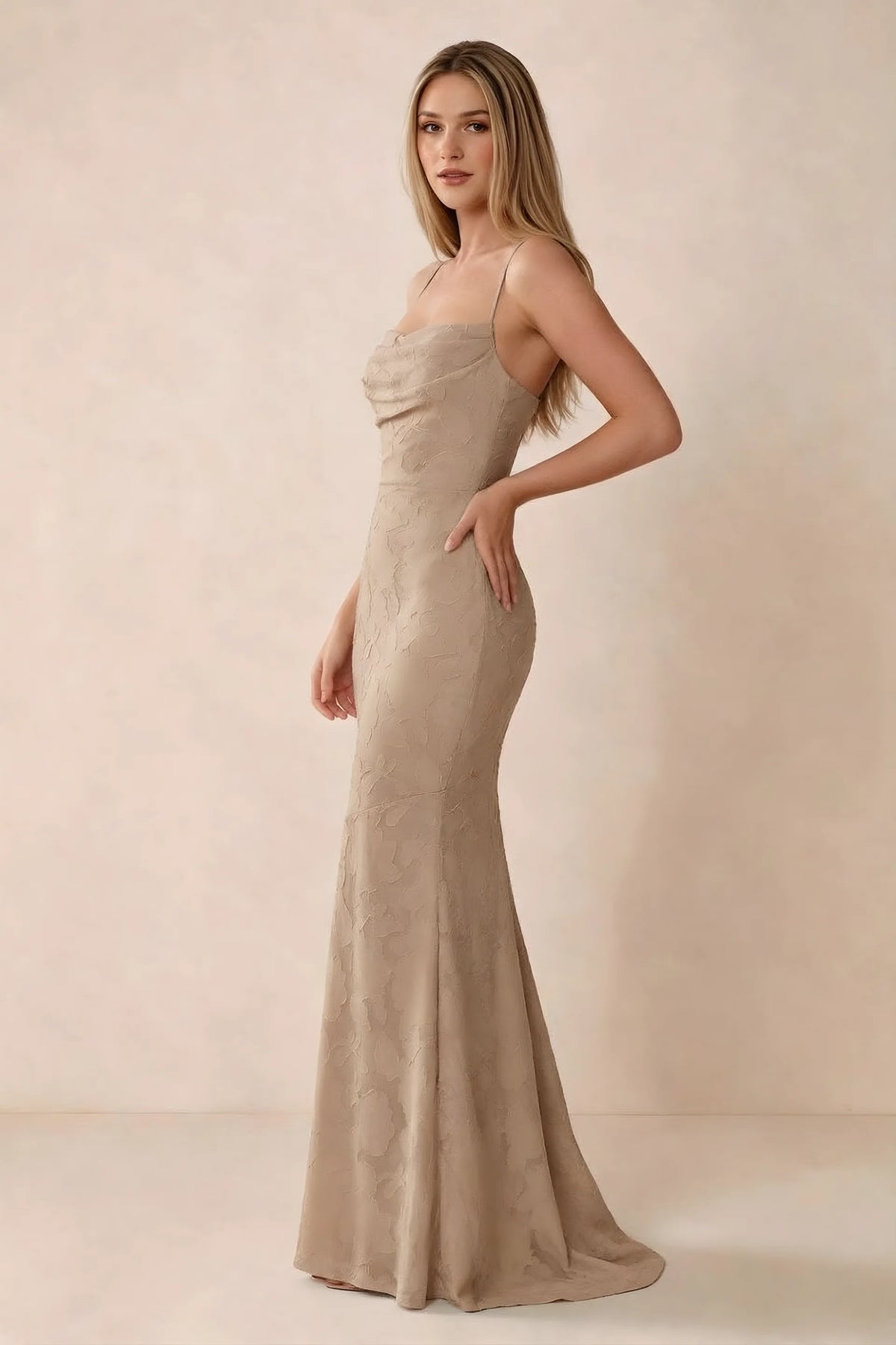 Three-quarter studio view of Bess champagne dress showing the close-fitting waist and gently flared hem