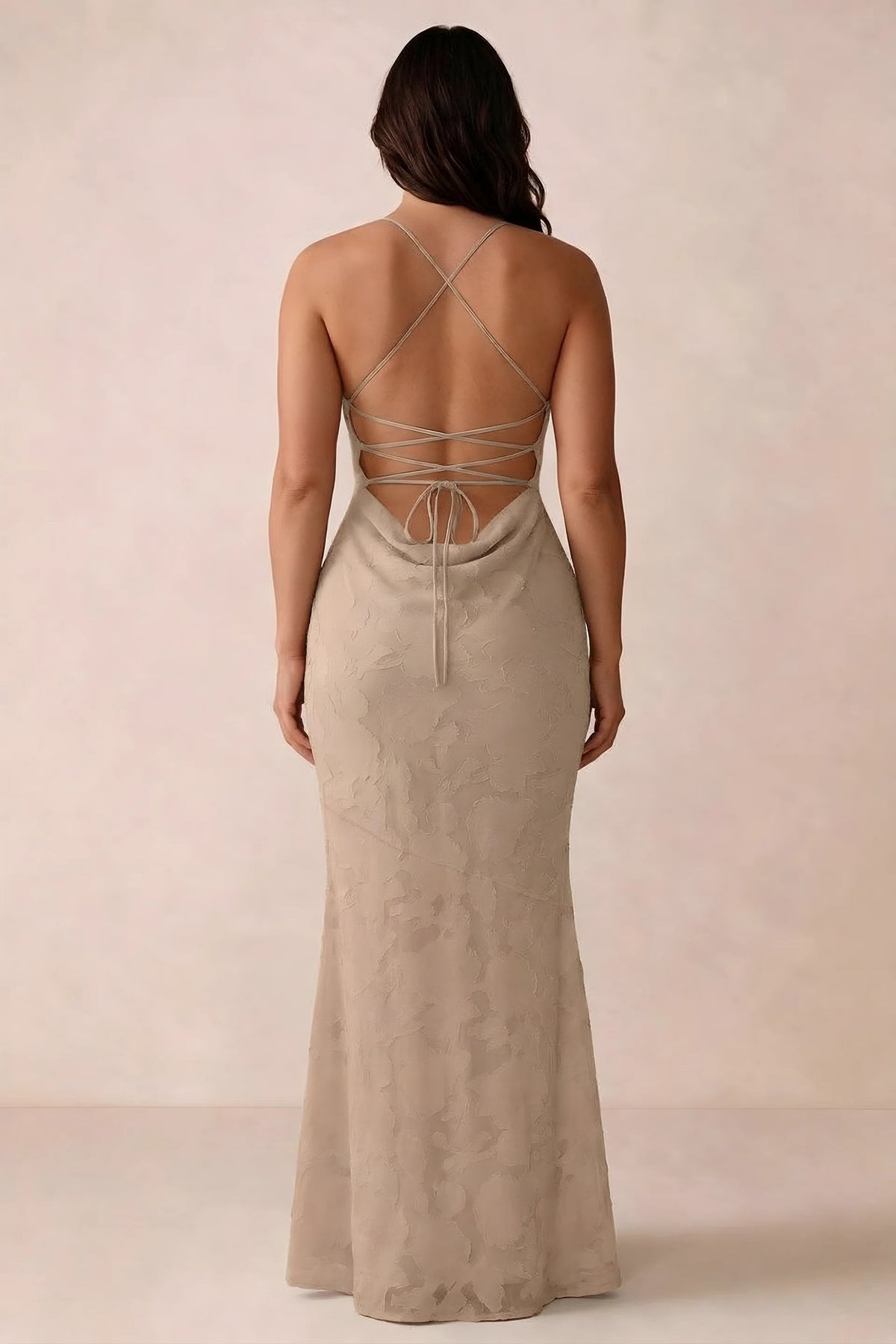 Back studio view of Bess champagne dress showing the crossed straps and full-length silhouette