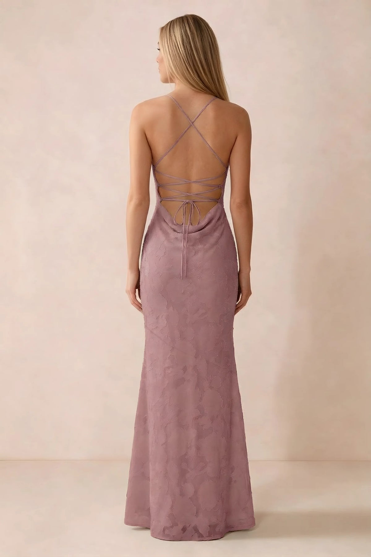 Rear studio view of Bess dusty pink dress showing cross-back lacing above a low cowl drape