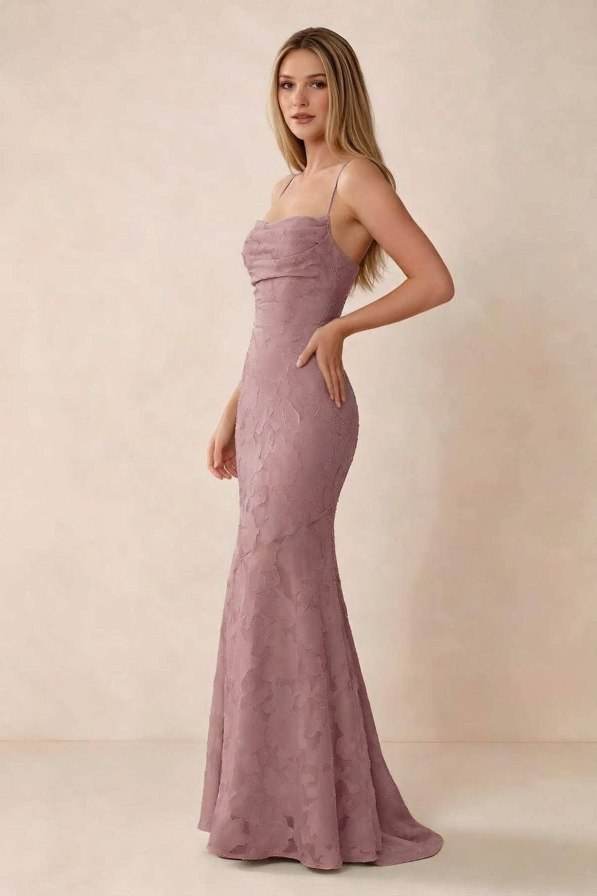Three-quarter studio view of Bess dusty pink dress showing the close-fitting waist and gently flared hem