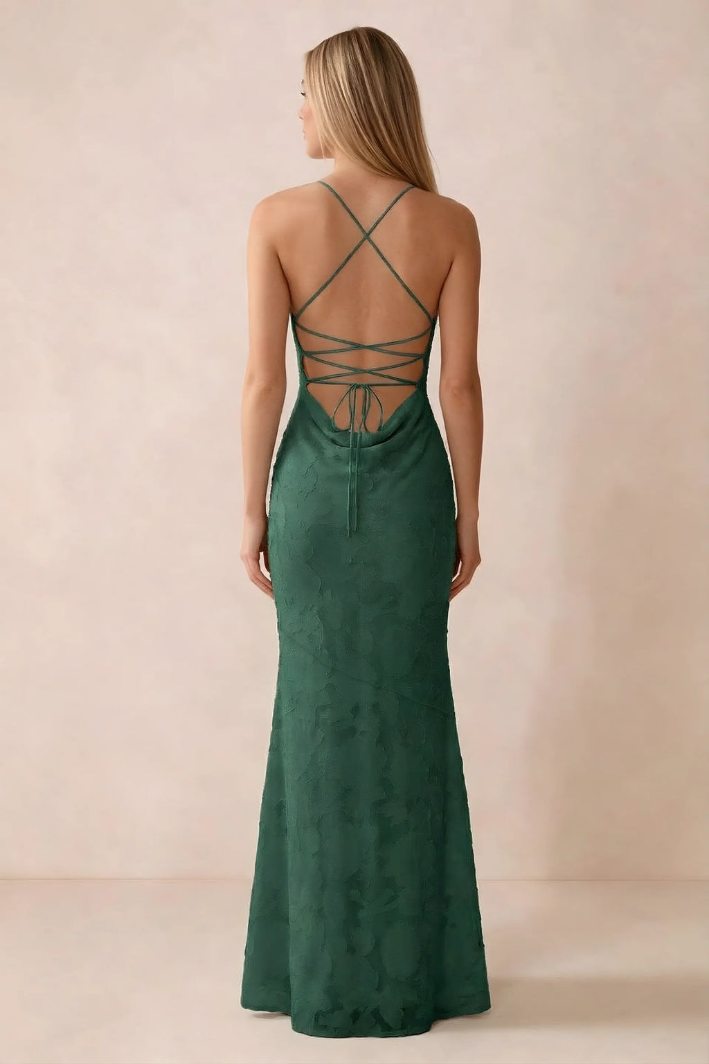 Rear studio view of Bess emerald green dress showing cross-back lacing above a low cowl drape