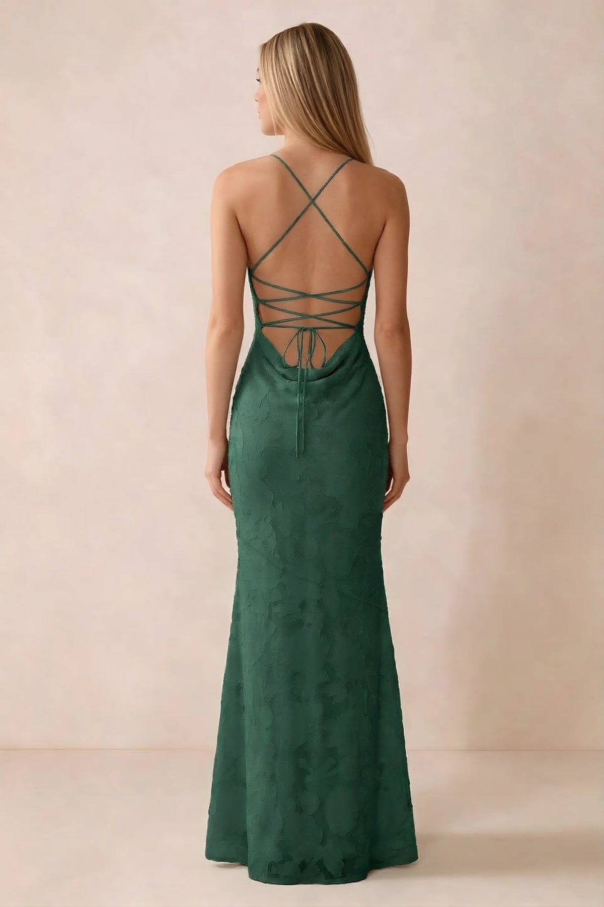Rear studio view of Bess emerald green dress showing cross-back lacing above a low cowl drape