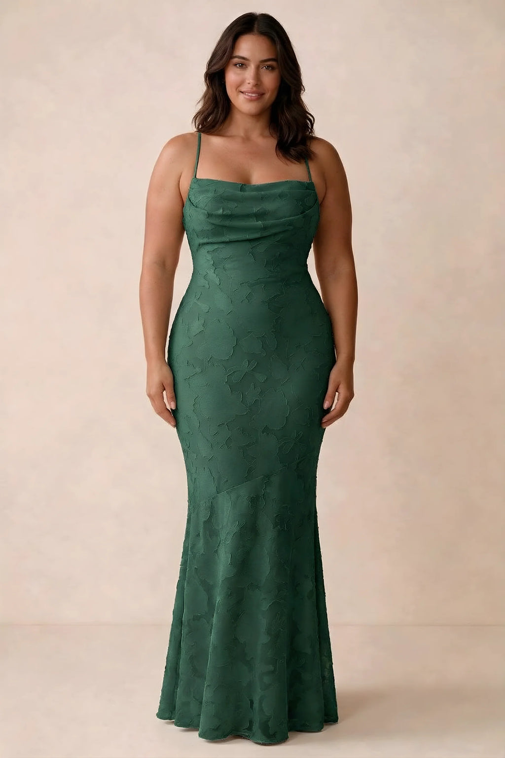 Front studio view of Bess emerald green maxi dress showing tonal floral texture and a long skirt