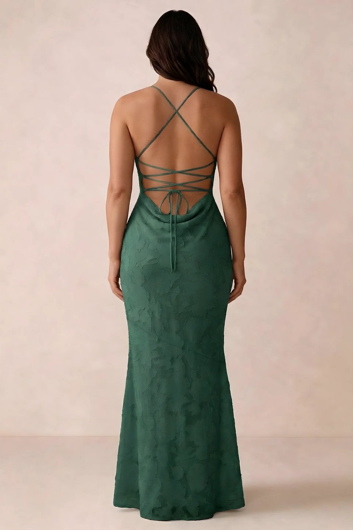 Back studio view of Bess emerald green dress showing the crossed straps and full-length silhouette