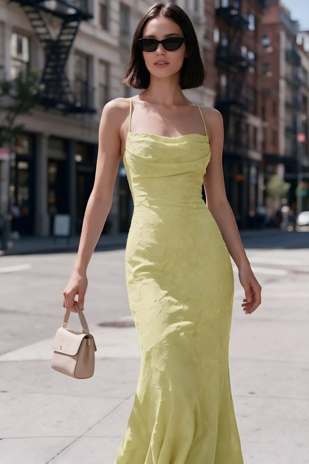Outdoor front view of Bess lemon floral burnout dress styled with sunglasses on a city street