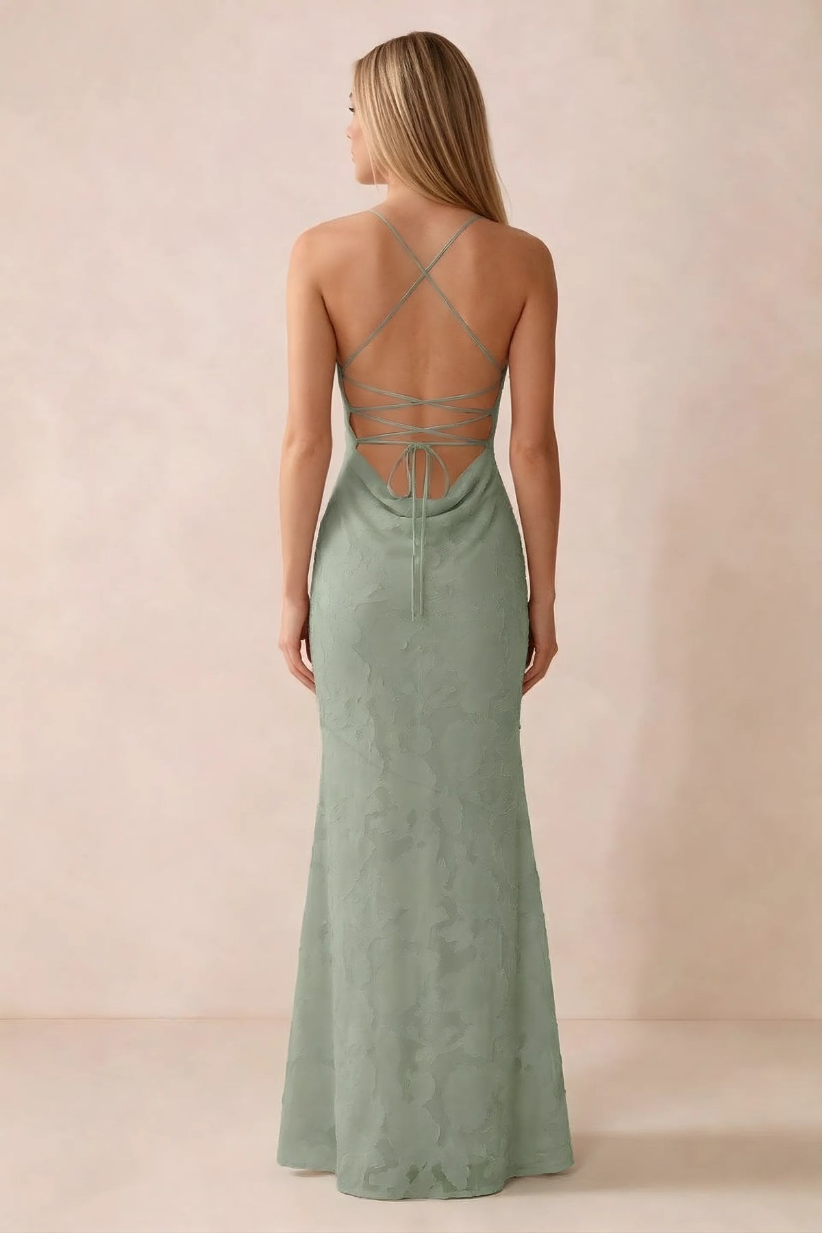 Rear studio view of Bess light green dress showing cross-back lacing above a low cowl drape