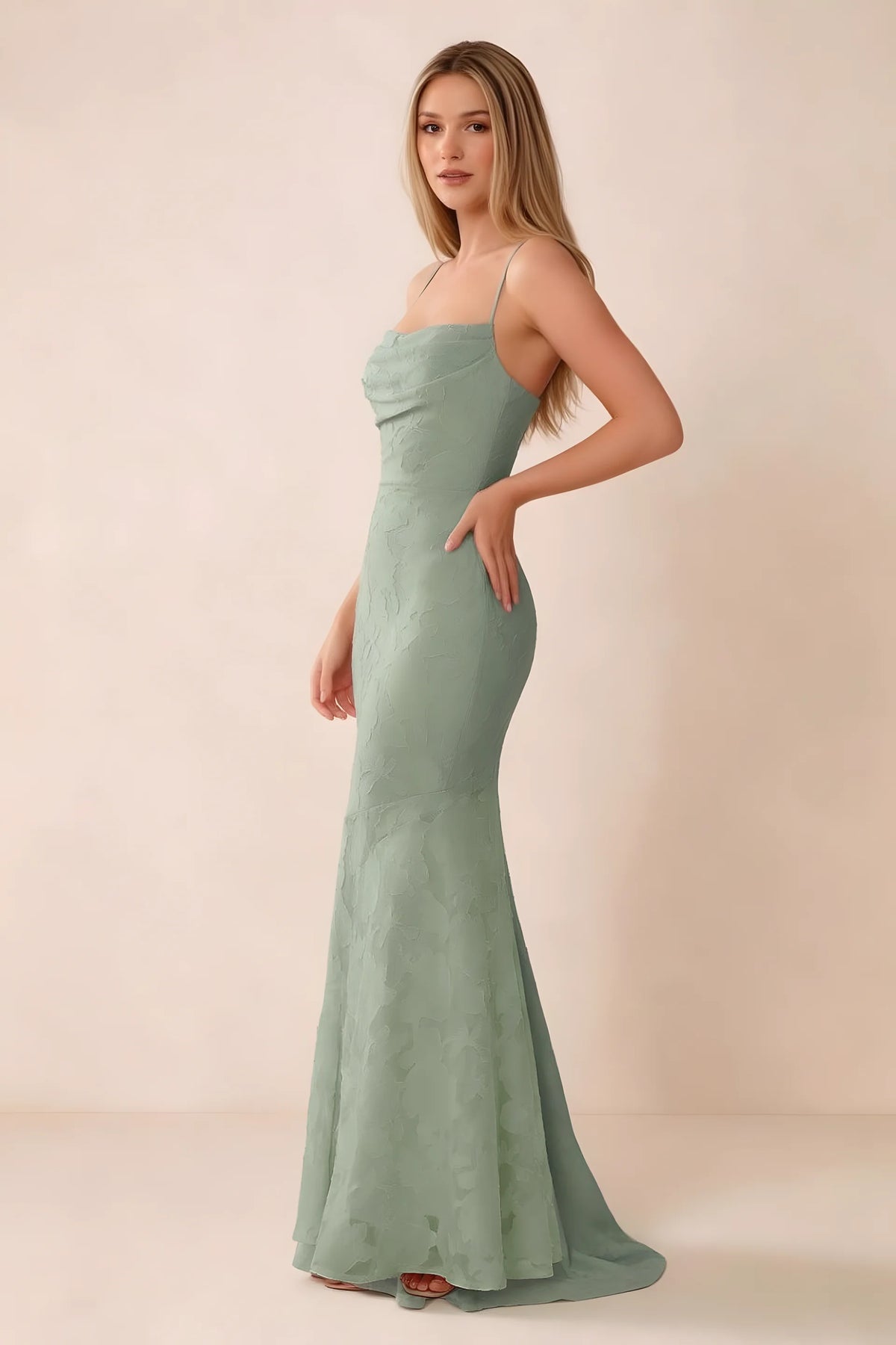 Three-quarter studio view of Bess light green dress showing the close-fitting waist and gently flared hem