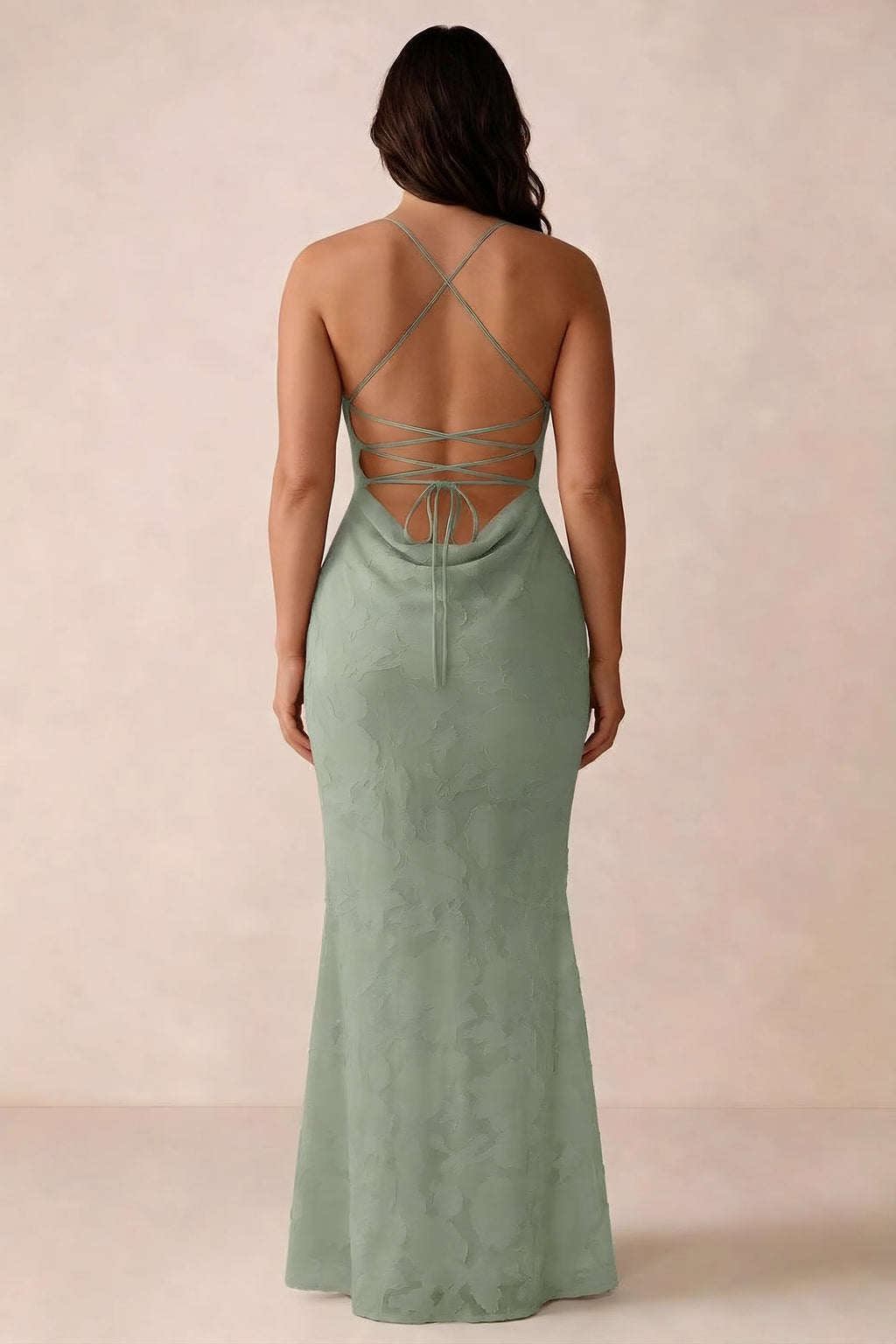 Back studio view of Bess light green dress showing the crossed straps and full-length silhouette